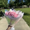 A timeless bouquet of classic pink roses, elegantly wrapped in paper to