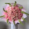 A refined floral composition designed in soft blush tones. This bouquet features