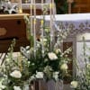 White roses and candles arranged in a wedding altar display