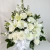 White floral arrangement with lilies, roses, and chrysanthemums in a white vase