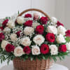 Basket of red and white roses with baby's breath