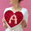 Heart-shaped box of red and pink roses held by a woman