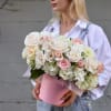 Bouquet of white and blush roses in a pink hatbox