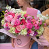Large pink and white mixed flower bouquet in a pink box