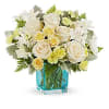 White roses and daisies arranged in a blue glass vase