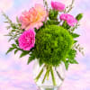 Pink and peach carnations with a green pompon chrysanthemum in a glass vase