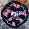 Pink and black rose bouquet with a heart-shaped horror movie topper