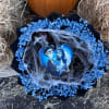 Blue baby's breath bouquet with a Halloween-themed topper