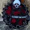 Bouquet of red and black roses with a skull doll and black ribbon