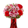 Red roses and pink lilies in a red glass vase