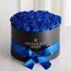 Blue roses arranged in a black round box with a blue ribbon