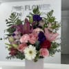 Mixture of lilies, roses, carnations, lisianthus, and daisies create a vibrant yet