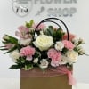 A charming basket arrangement featuring a soft blend of blush pink and