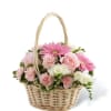 Pink and white flowers arranged in a wicker basket