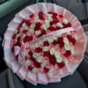 Round bouquet of red, pink, and white roses with a birthday ribbon
