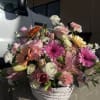 Mixed pink and white flower arrangement in a white basket