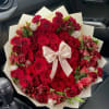 Large bouquet of red roses and red alstroemeria with a satin bow