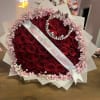 Heart-shaped bouquet of red roses with pink baby's breath and a pearl crown