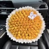 Large bouquet of yellow roses wrapped in white paper with a white ribbon