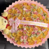 Round bouquet of pink and yellow roses with a teddy bear and birthday ribbon