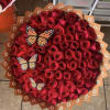 A tightly packed, round bouquet of red roses that reads pure romance