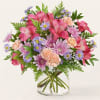 Pink and lavender mixed bouquet in a clear glass vase
