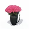 Pink rose bouquet in a black vase with a ribbon