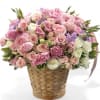 Pink and white rose bouquet in a woven basket