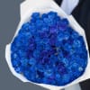 Bouquet of blue and purple roses wrapped in white paper