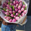 A stunning bouquet of fresh pink tulips, elegantly wrapped in crisp white