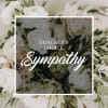 White sympathy bouquet with mixed blooms and greenery