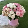 Pink and white rose bouquet in a pink container