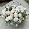 White peony basket arrangement with eucalyptus and a woven handle