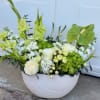 White vase arrangement with green gladiolus, roses, and hydrangeas