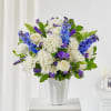 White and purple mixed bouquet in a white vase