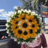 Bouquet of yellow sunflowers and roses wrapped in paper