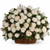 White and blush roses arranged in a wicker basket