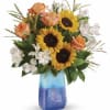Sunflowers, peach roses, and white alstroemeria in a blue vase