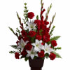 Red carnations and white lilies arranged in a dark vase