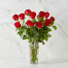 Red roses arranged in a clear glass vase