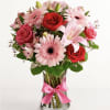 all- around arrangement pink and red flowers, designed in a clear glass