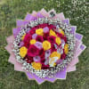 Bouquet of pink, yellow, and lavender roses with white baby's breath
