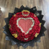 Heart-shaped red rose arrangement with a crown and black wrapping