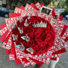 Large bouquet of red roses with butterfly decorations and a jeweled crown