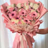 Large pink bouquet with roses, gerbera daisies, and carnations wrapped in pink paper