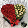 Heart-shaped box of red roses and gold-wrapped chocolates with a red ribbon