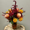 A sweet colorful arrangement designed with sweet, rich colors of flowers. 
