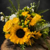 Golden sunflowers and sunny yellow roses take center stage in this cheerful