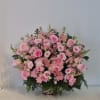 Large pink flower arrangement in a woven basket