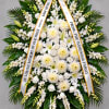 White funeral wreath with ribbon tribute and mixed blooms
